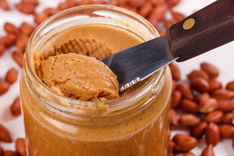 Peanut butter contains oil components that can dissolve sticky adhesives as a solvent