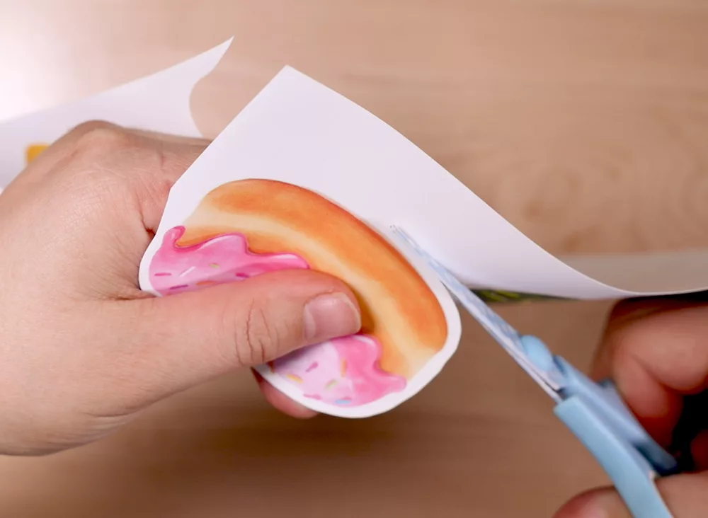 Cuting out stickers with scissors