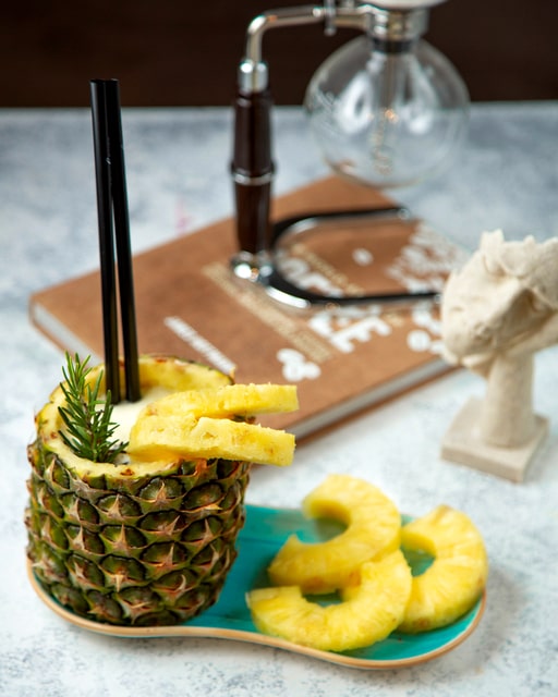 Use a hollowed-out pineapple for a tropical drink holder