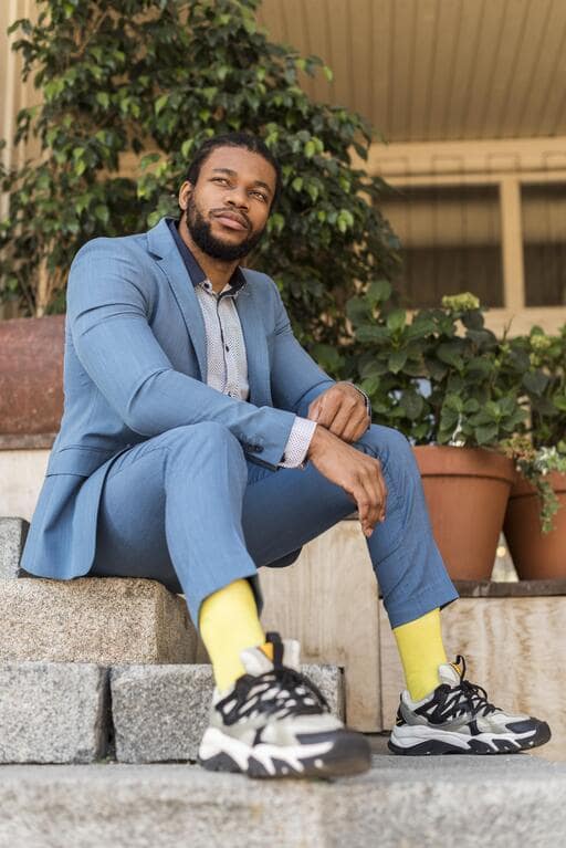 Man wearing tailored suits paired with sneakers