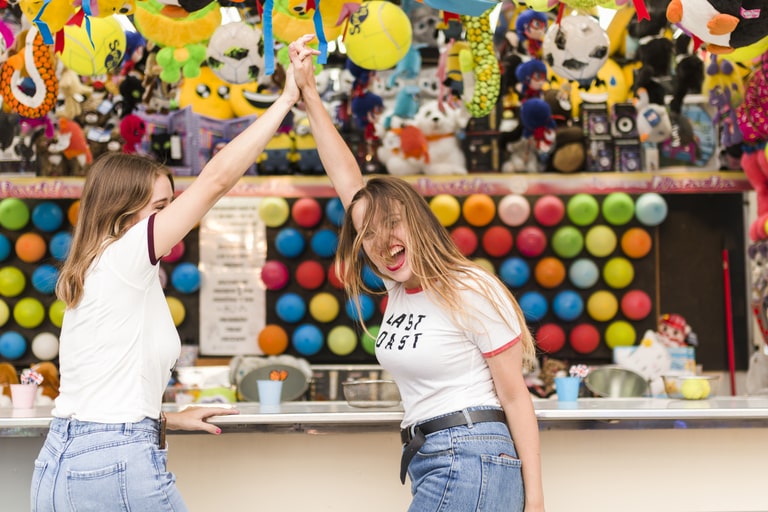 Happy friends playing games together at a Carnival themed party